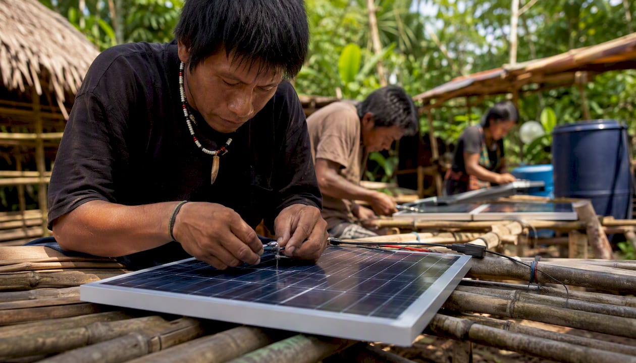 Hands installing solar panel in Amazon community