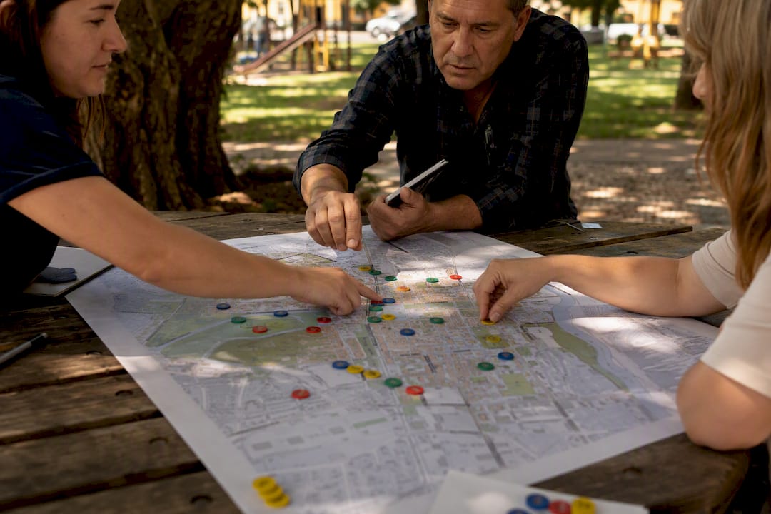 Hands placing tokens on community engagement map