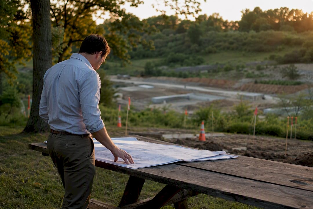 Developer examining site plans at construction edge