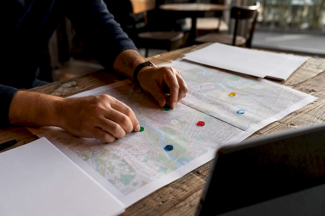 Hands placing markers on decision-maker map