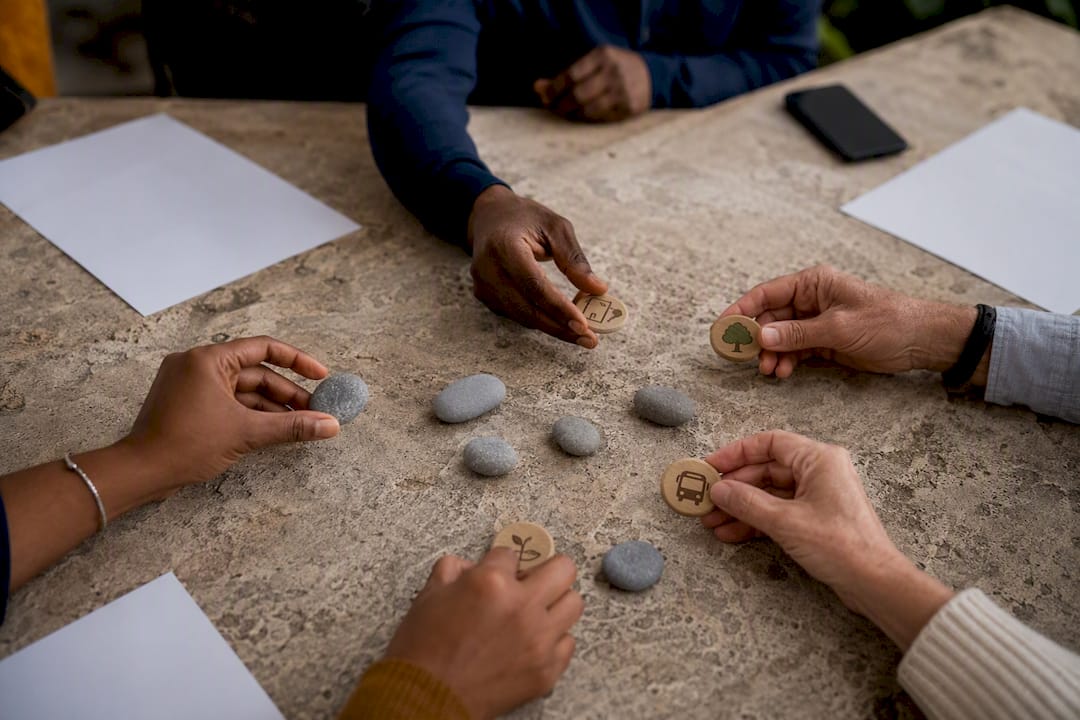 Hands exchanging tokens in small group