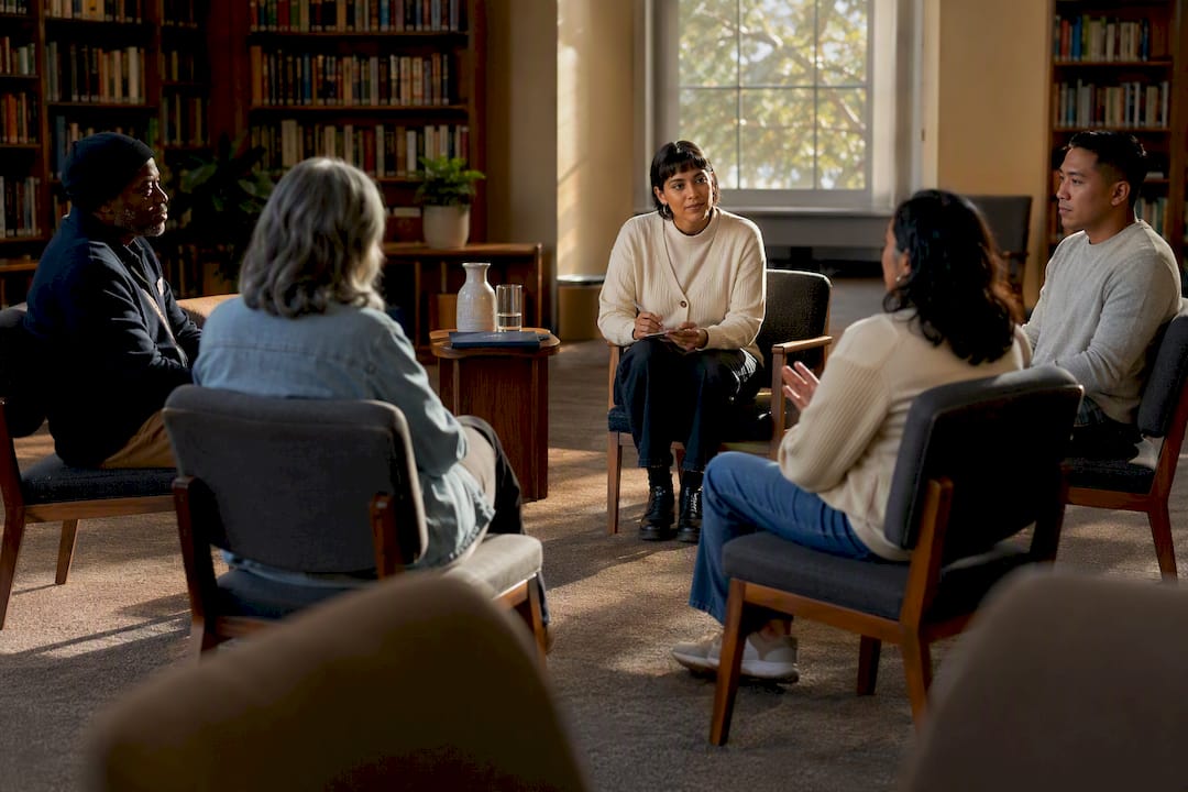 Facilitator listening to residents in meeting