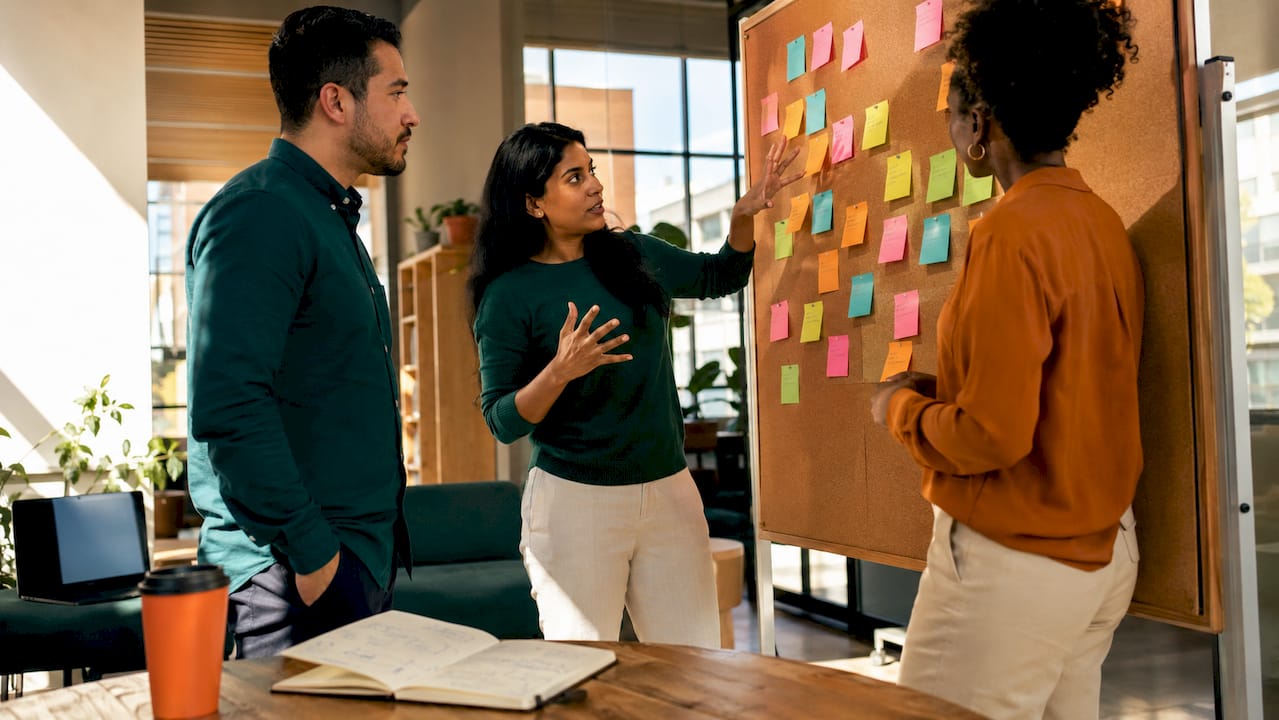 Hands sorting keyword strategy sticky notes in office