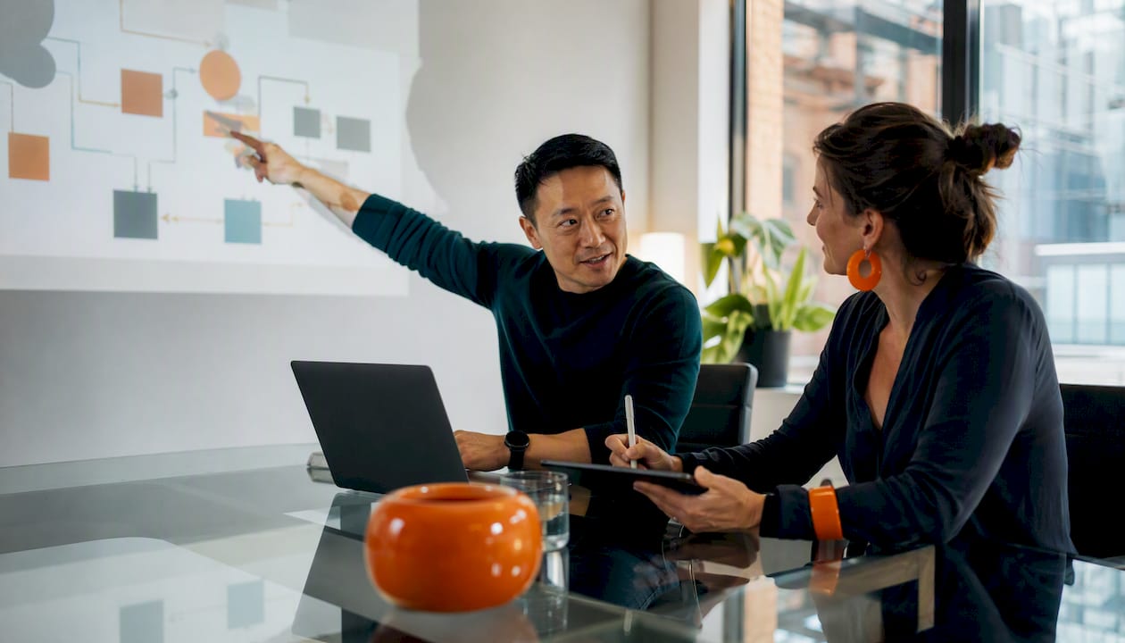 Hands collaborating on content workflow diagram