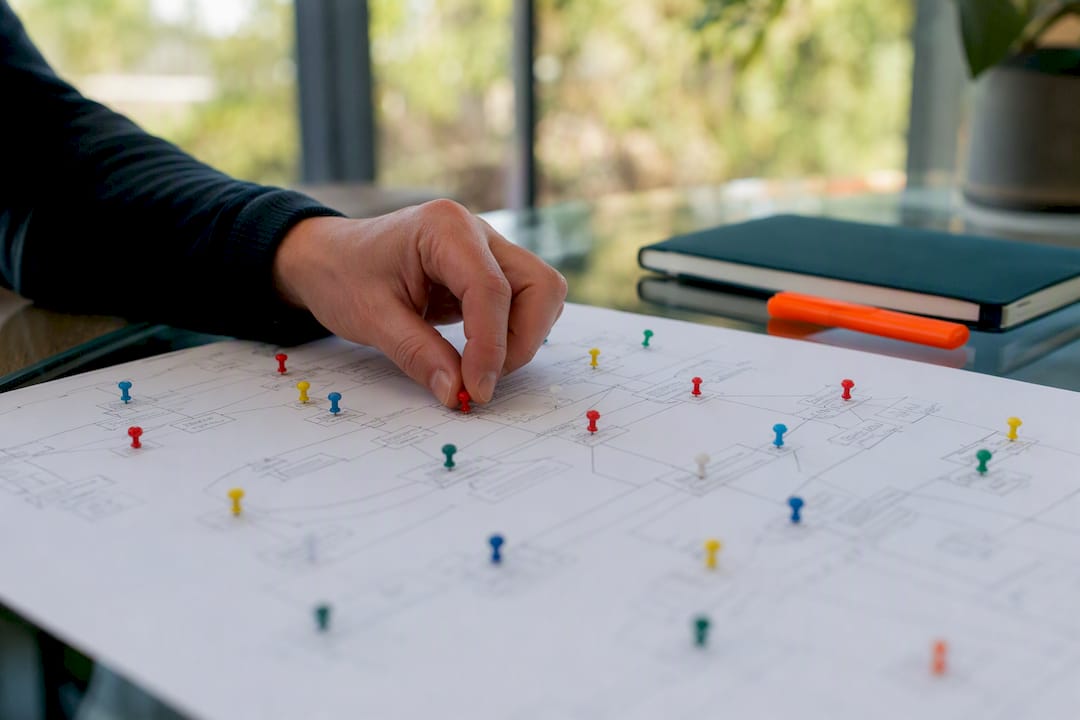 Hand placing pin on SaaS SEO content map