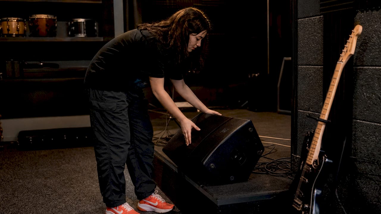 Musician adjusting onstage monitor speaker