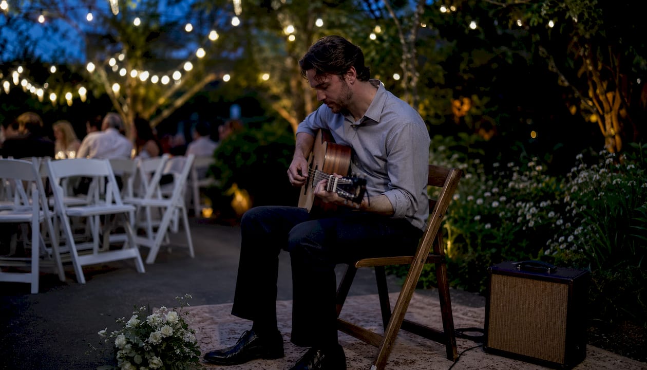Solo guitarist playing at outdoor wedding