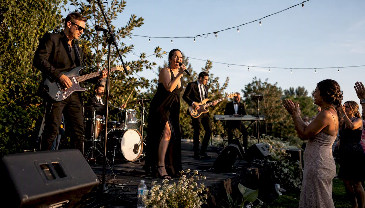 Wedding band performing live in rustic warehouse venue