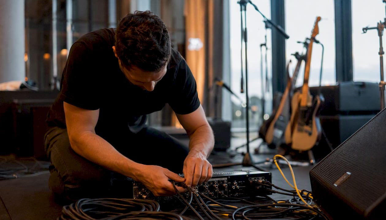 Technician connecting sound equipment at wedding venue