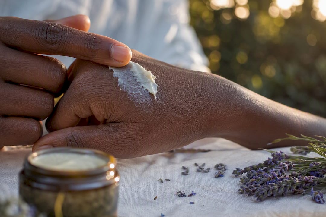 Finger smoothing balm into dry skin texture
