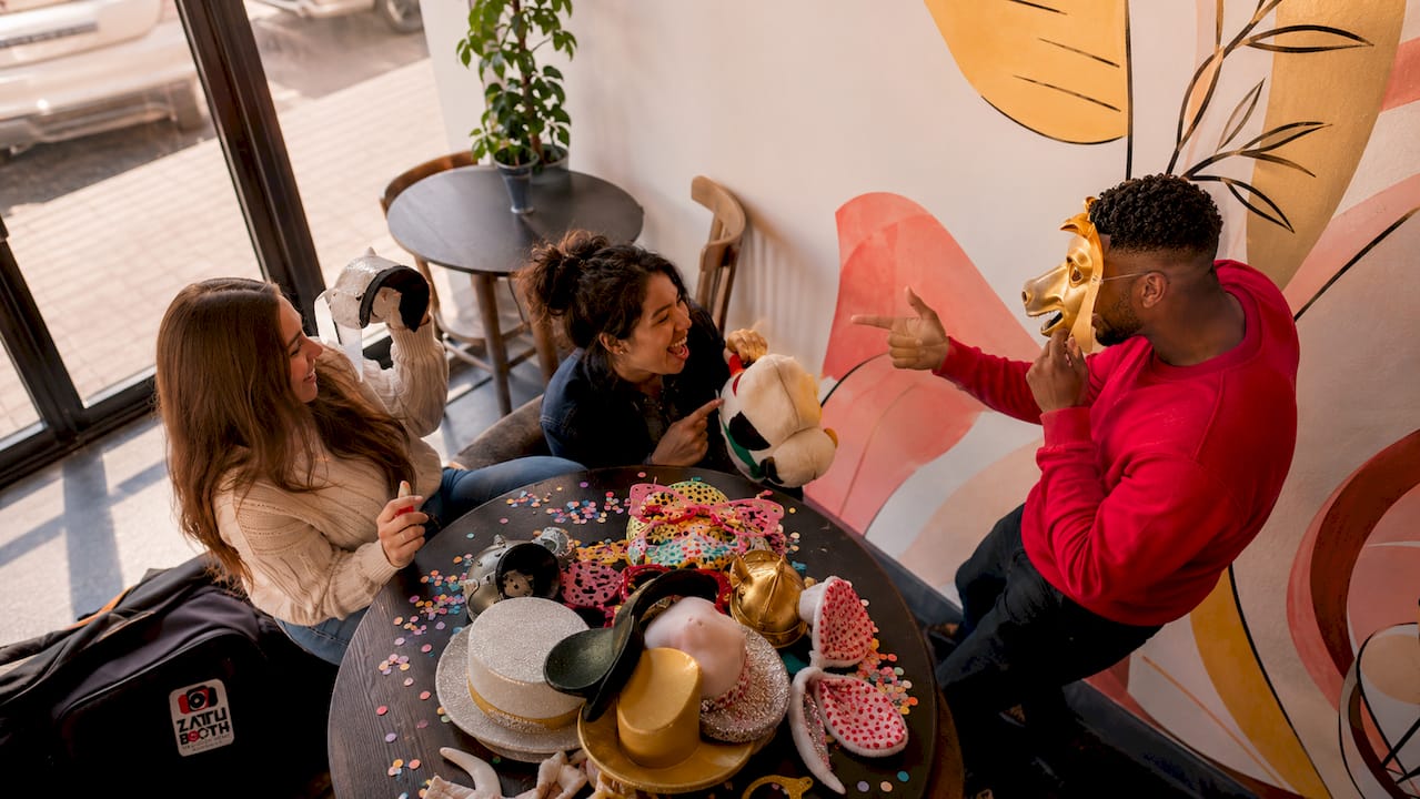 Guests using playful photo booth props
