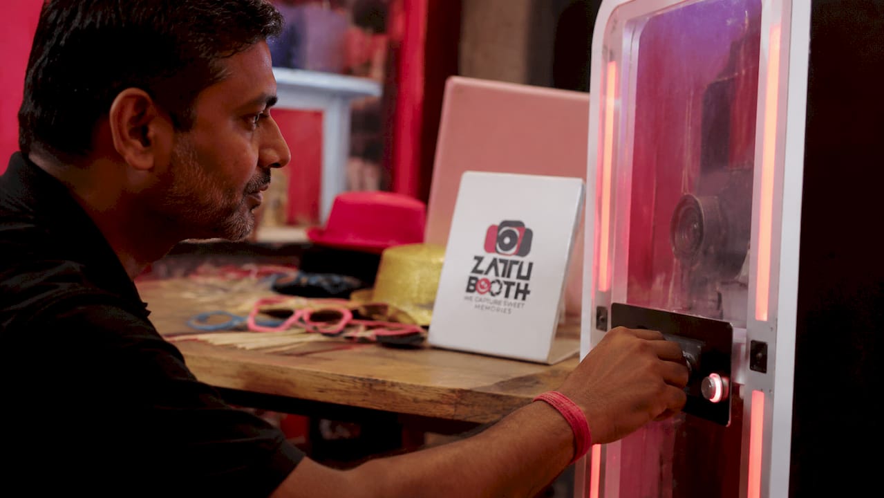 Man adjusting AI photo booth controls in studio