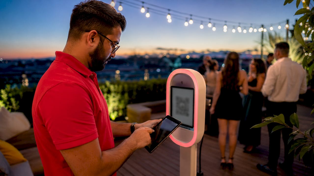 Technician managing photo booth digital delivery
