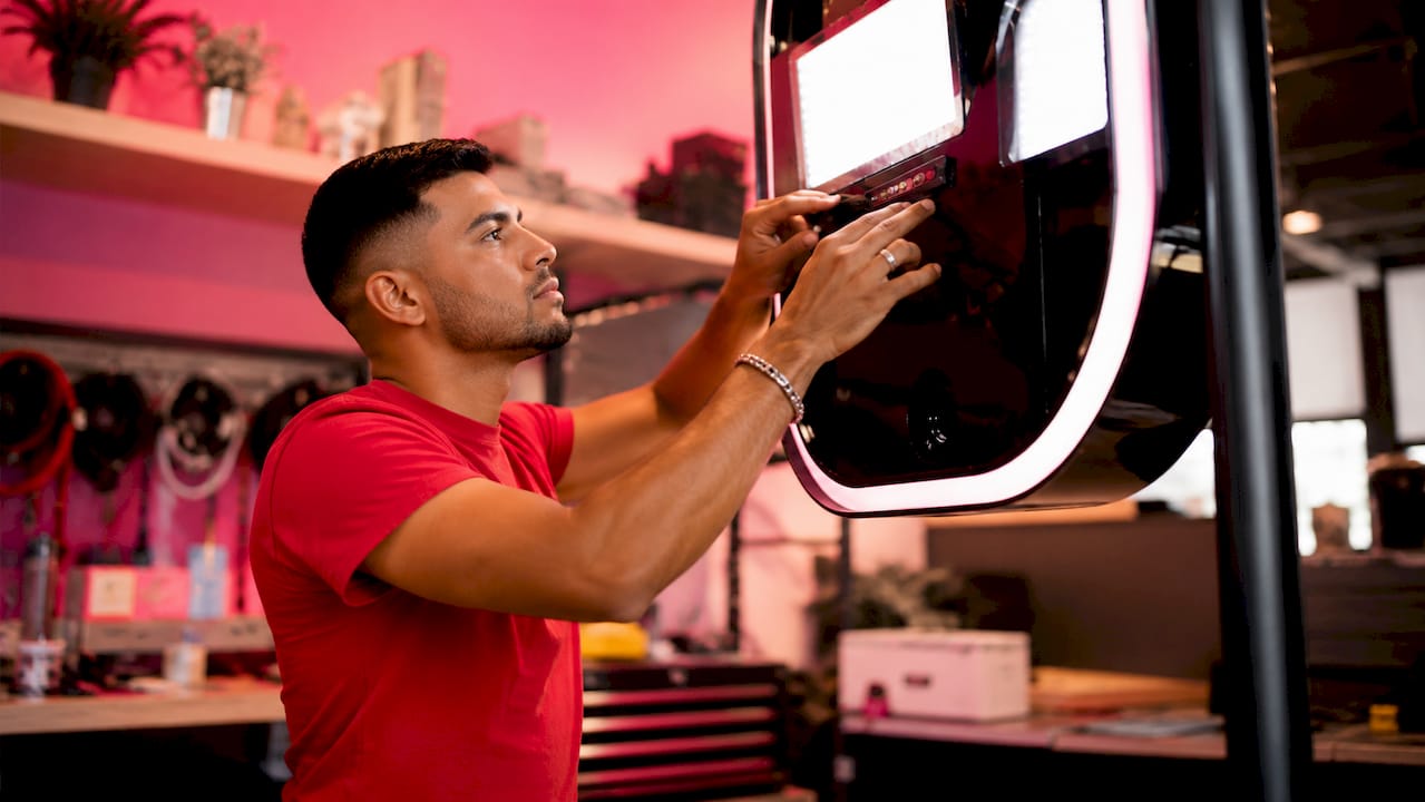 Technician adjusting photo booth LED lighting hardware