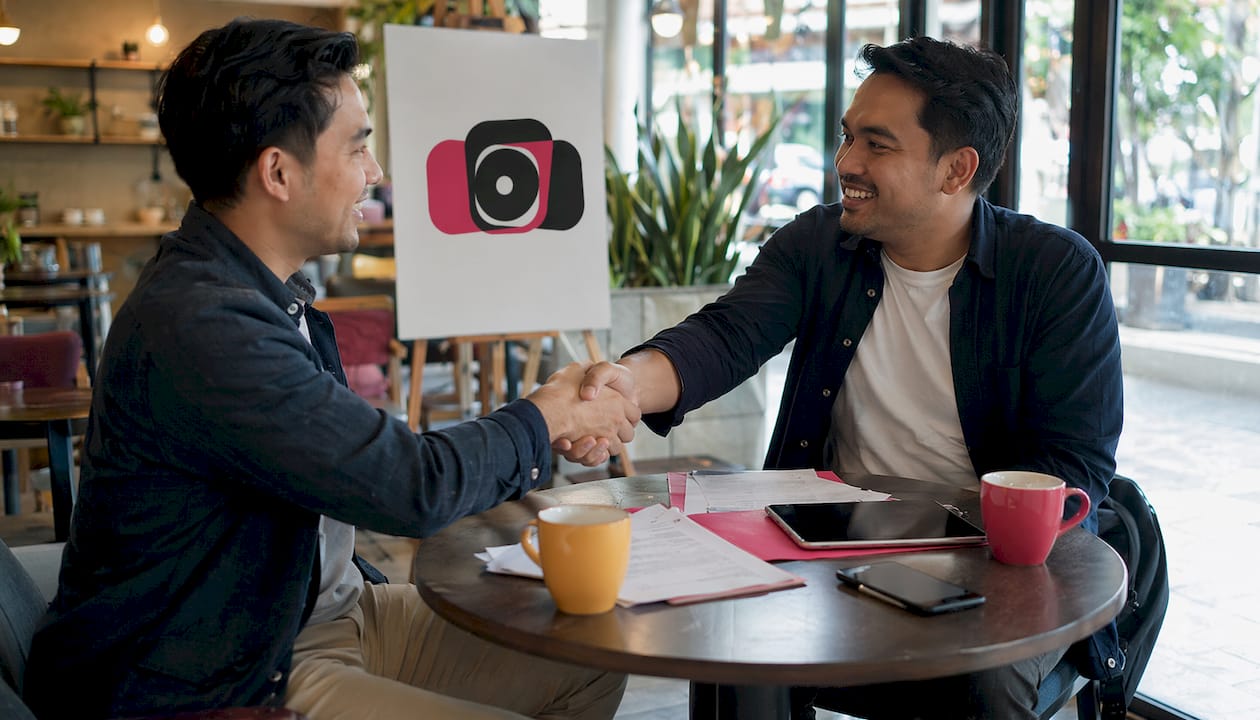 Vendor and venue manager handshake during meeting