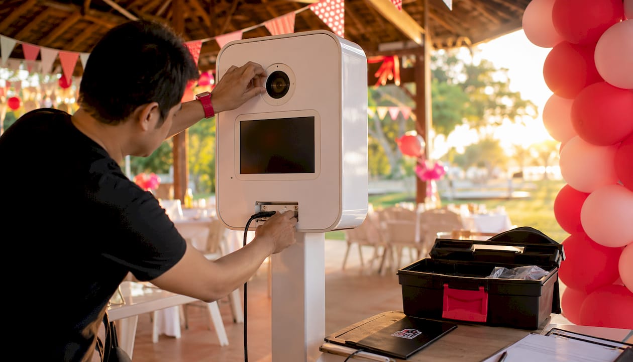Close-up of hands setting up photo booth