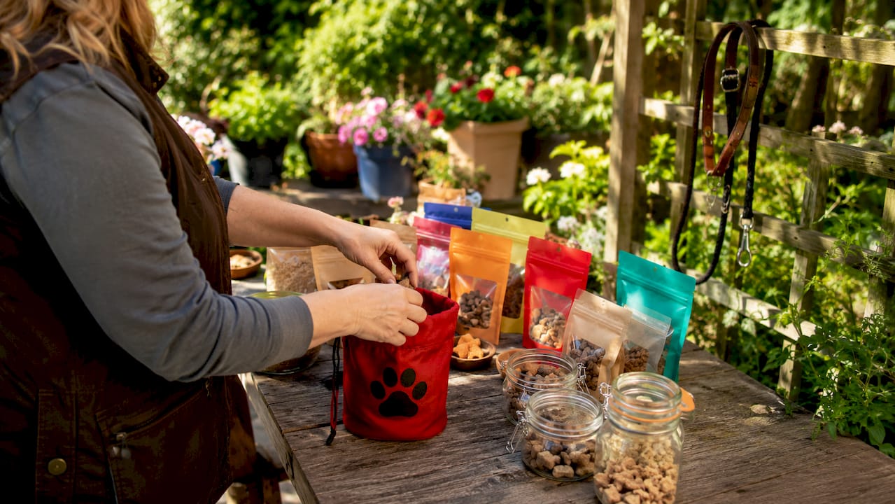 Hands packing dog treats for training rewards