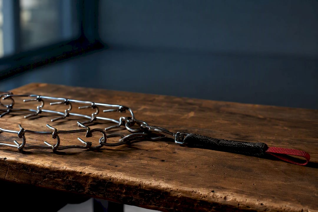 Prong collar and leash on training bench