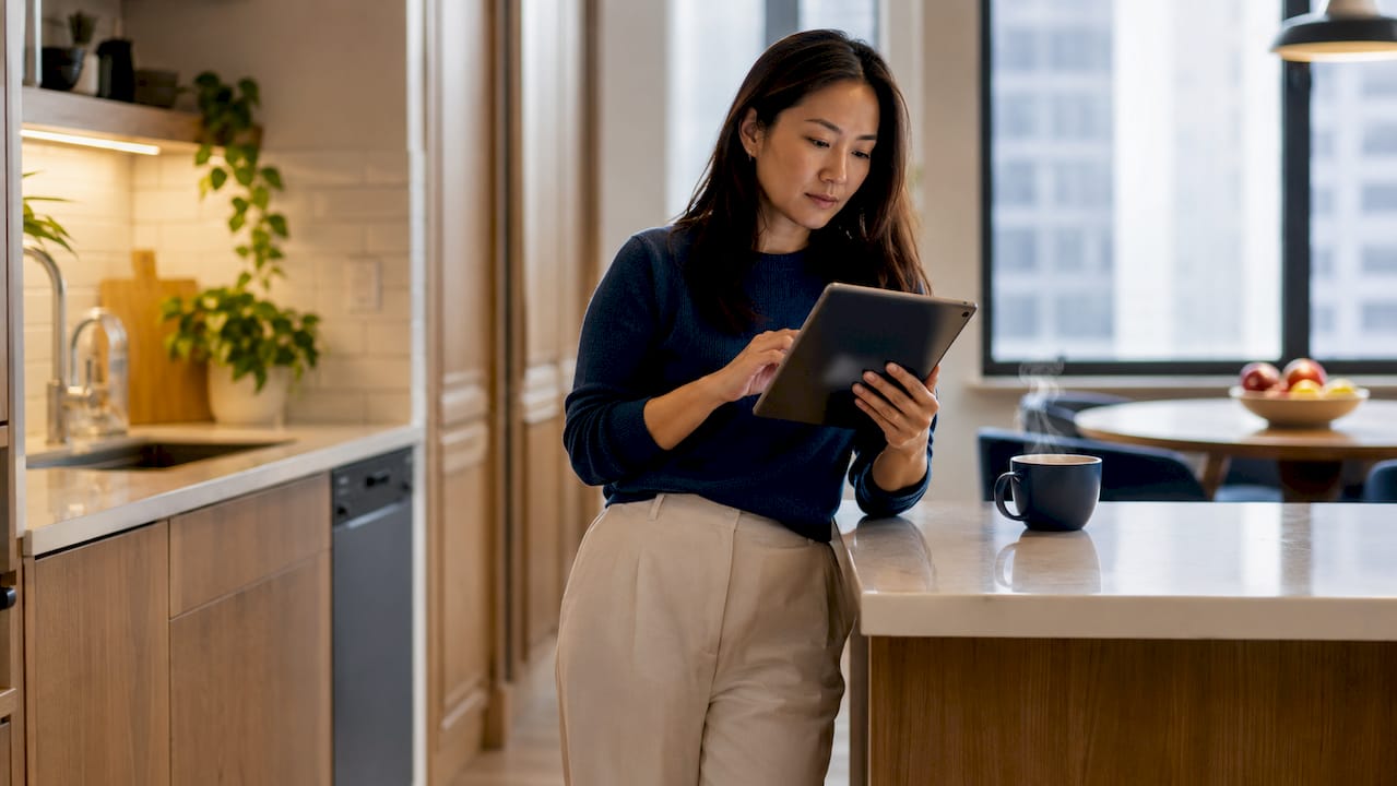 Woman reviewing daily AI update on tablet at home office