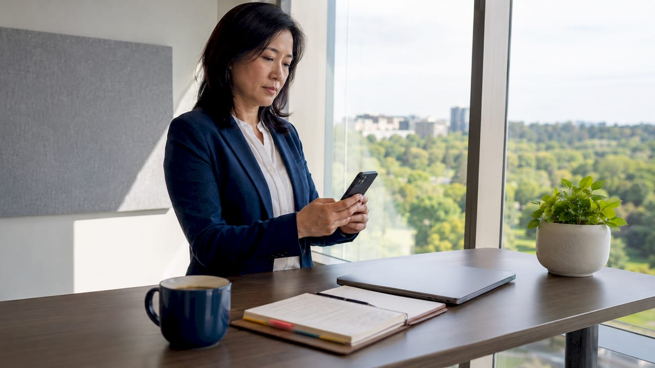 Business leader reading AI update on smartphone