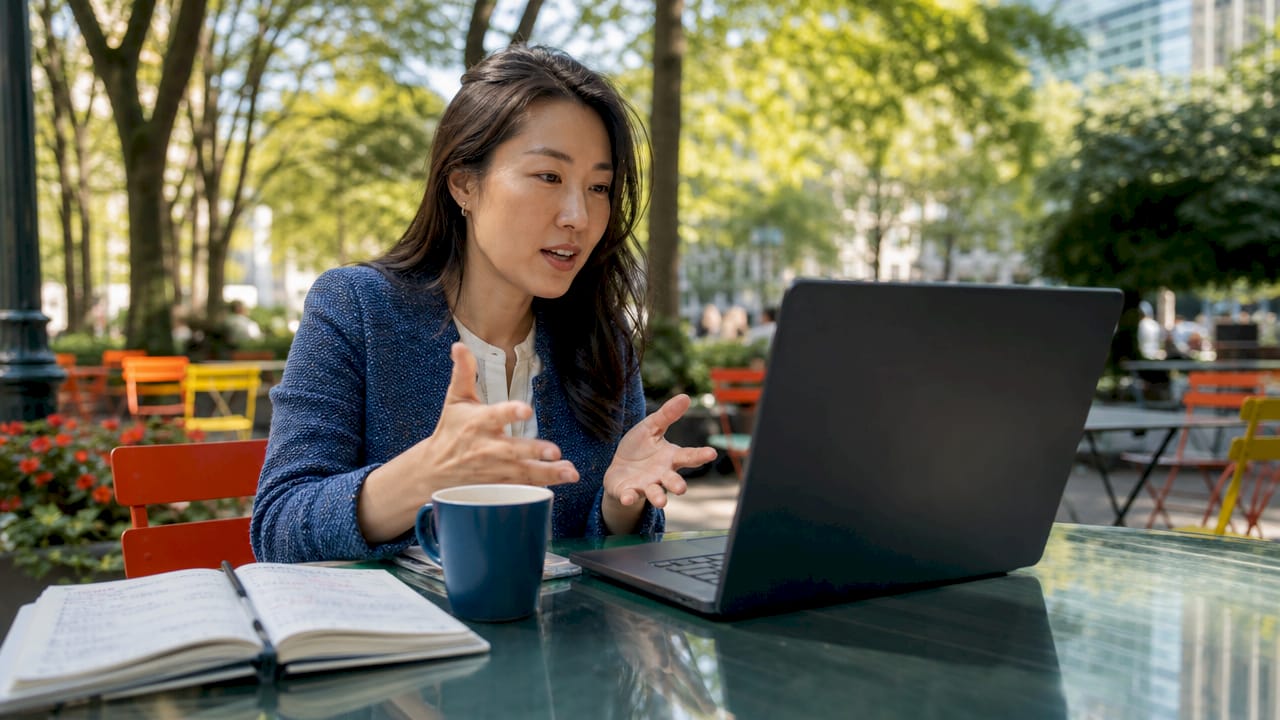 Woman using laptop for AI update feed