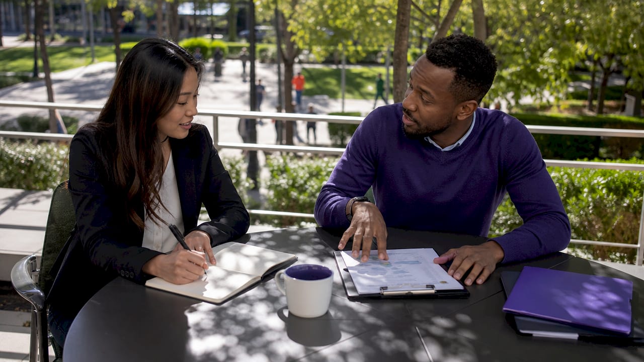 Professionals discussing documents in secure meeting room