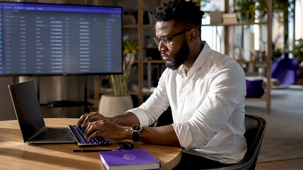 Hands typing on investor database computer
