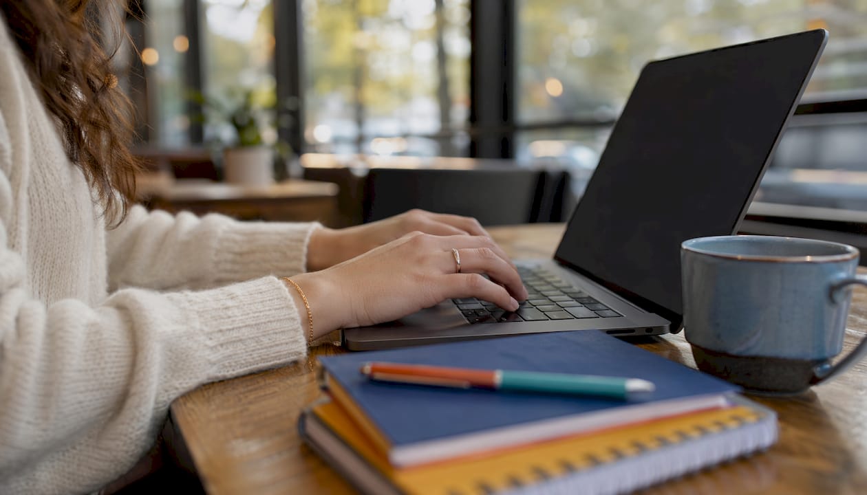 Hands typing on keyboard in coworking space