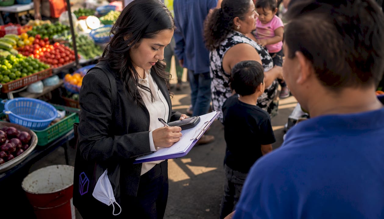 Sales representative recording data in retail street