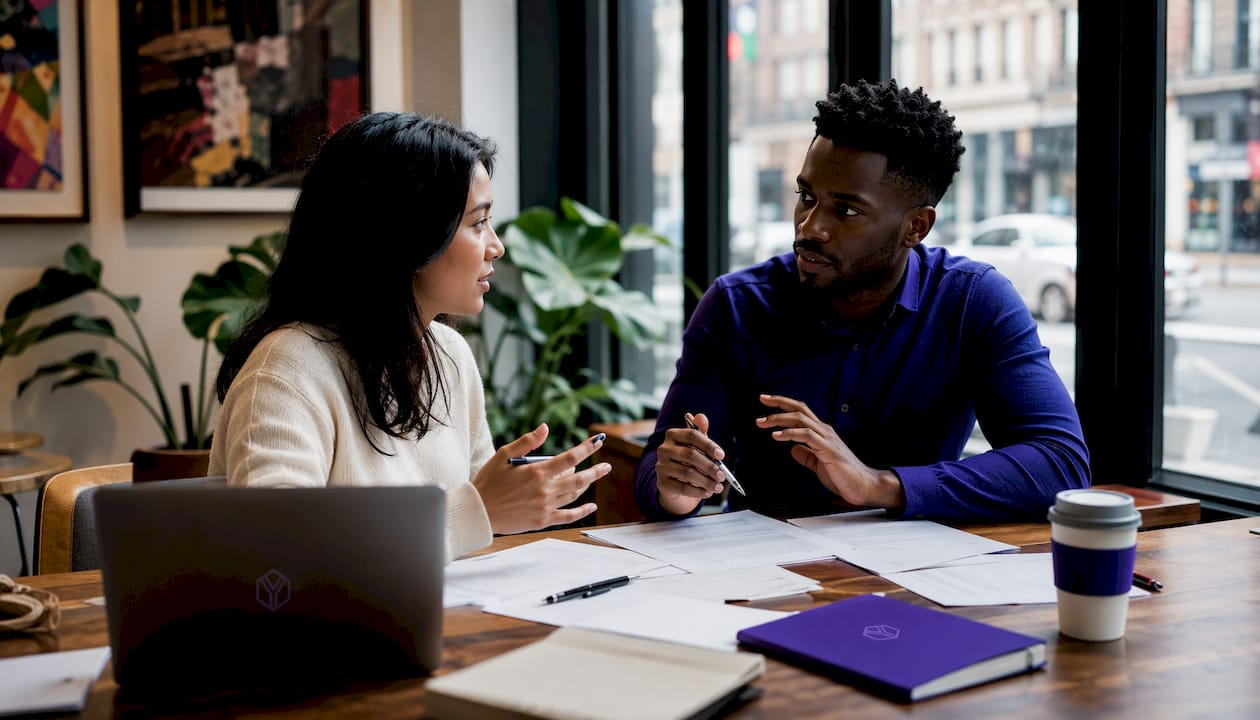 Entrepreneurs negotiating startup term sheets at table