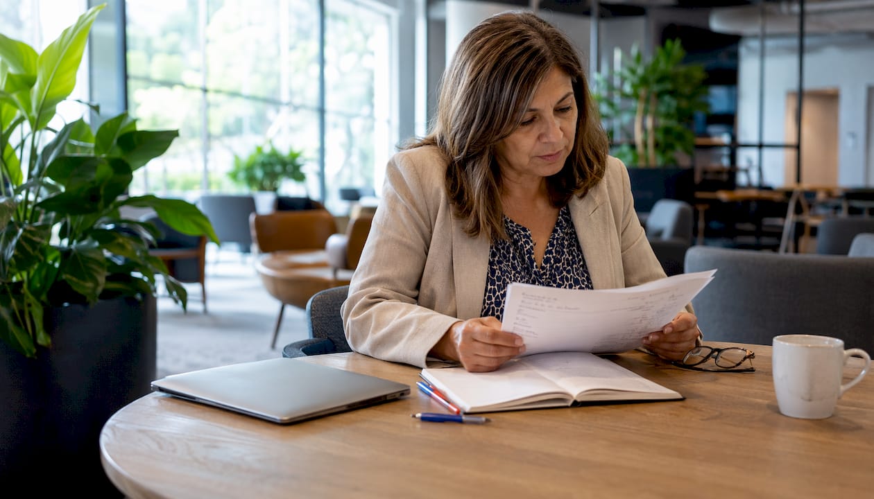Leader reviewing sourced document at desk