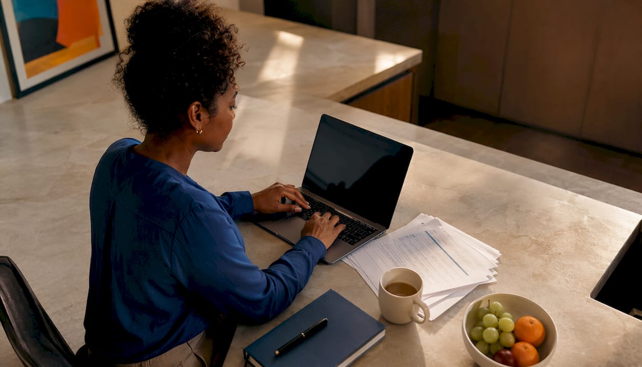 Leader working on laptop integrating meeting notes GitHub calendar