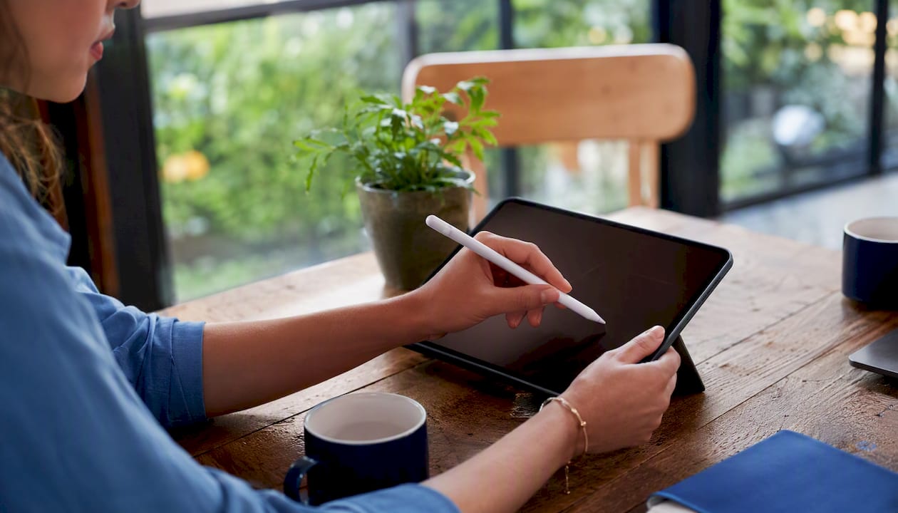 Hands tagging digital context on a tablet