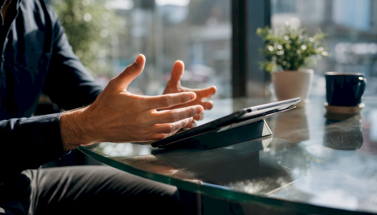 Hands managing pitch deck on tablet
