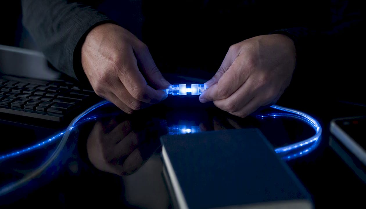 Hands connecting digital data cables