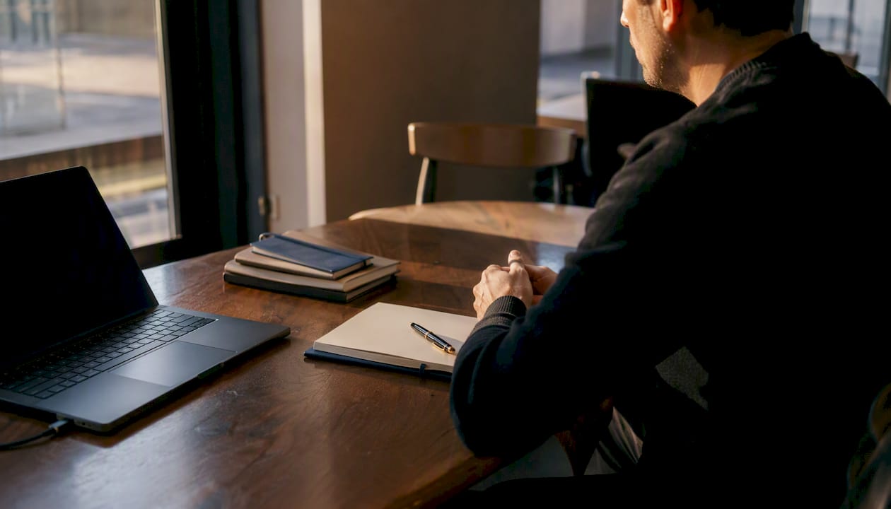 Executive desk with briefing materials and dark laptop