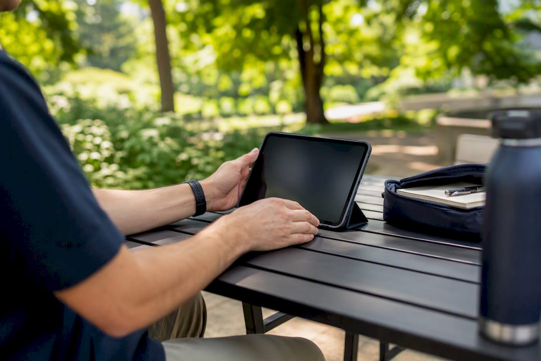 Founder hands adjusting tablet at modern coworking space