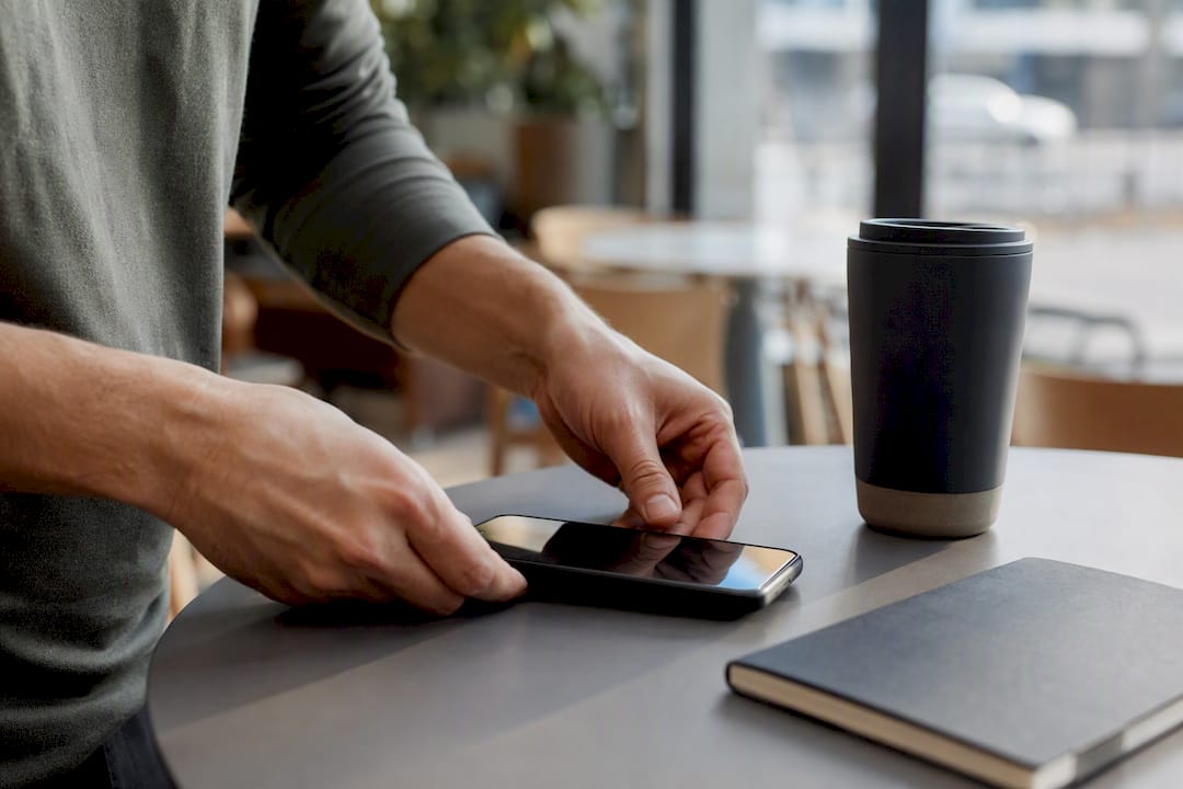 Founder hands with phone on desk