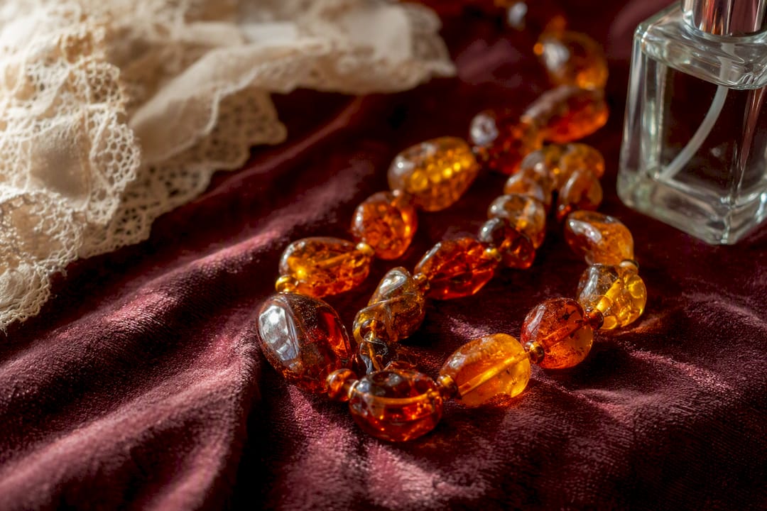 Close-up of amber beads on fabric