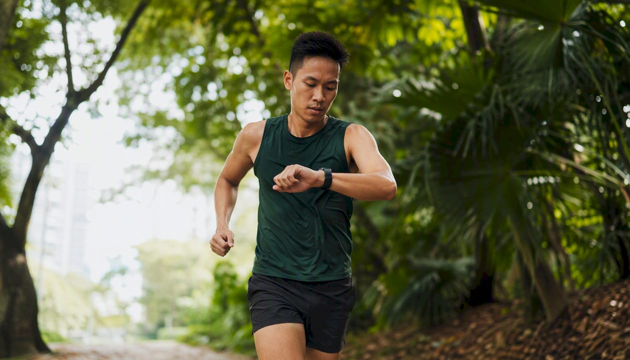 Runner checking GPS smartwatch during run