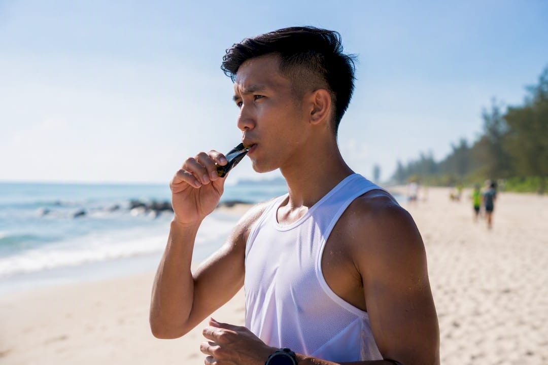 Athlete opening energy gel snack pre-race