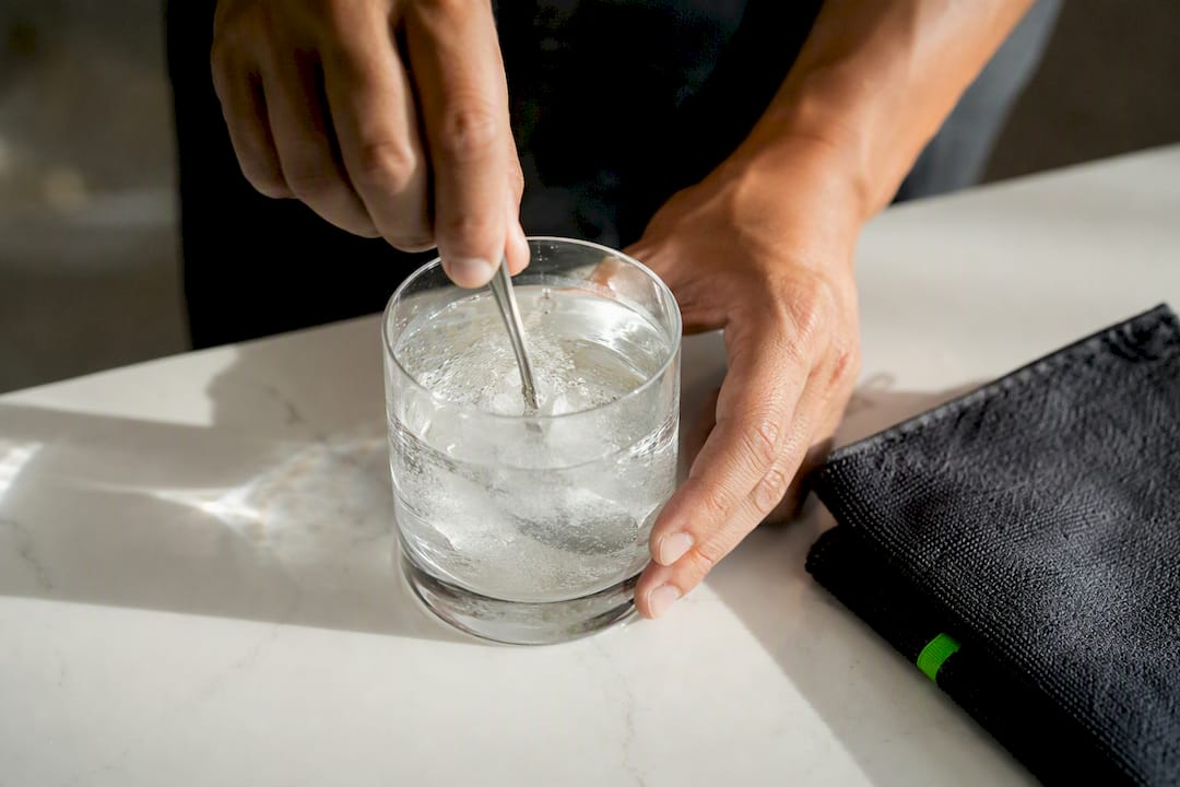 Powder dissolving in a glass of water