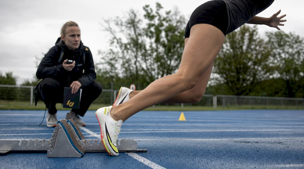 Sprinter's feet pushing off starting blocks on track