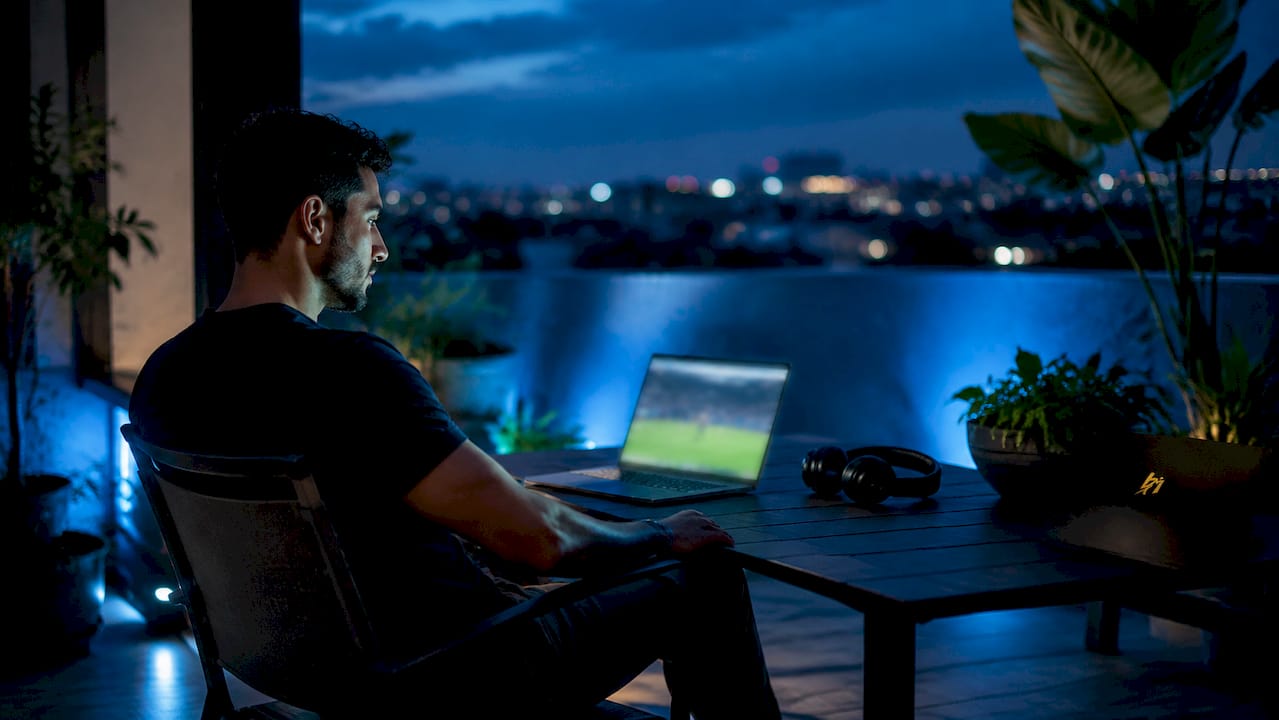 Man streaming live sports event at home setup