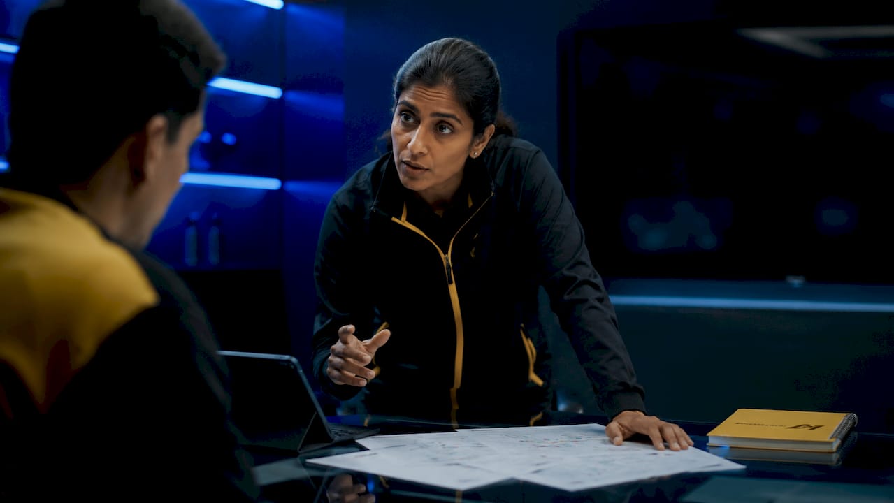 Coach making tactical decisions with staff