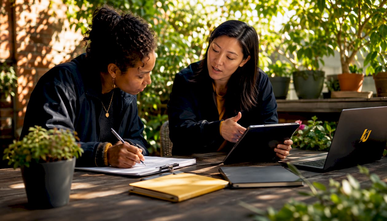 Staff discussing software options at meeting table
