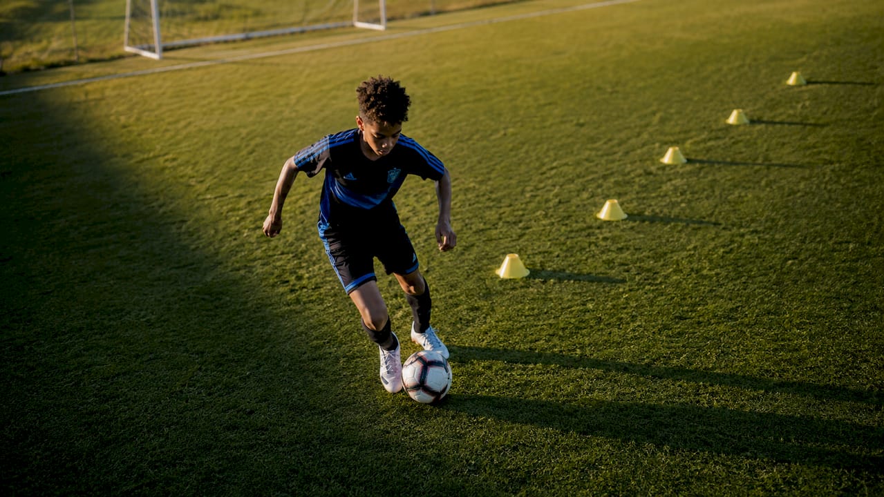 Youth athlete sprinting in football drill