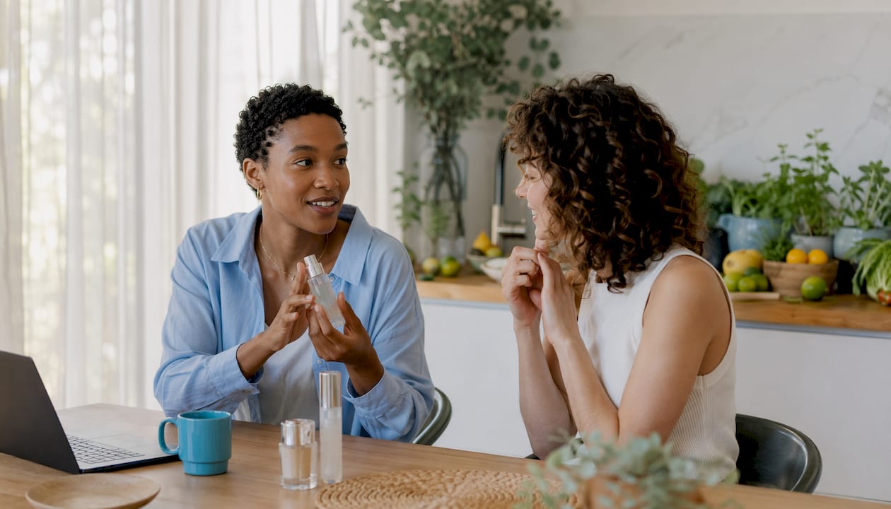 Two friends sharing skin scent discussion