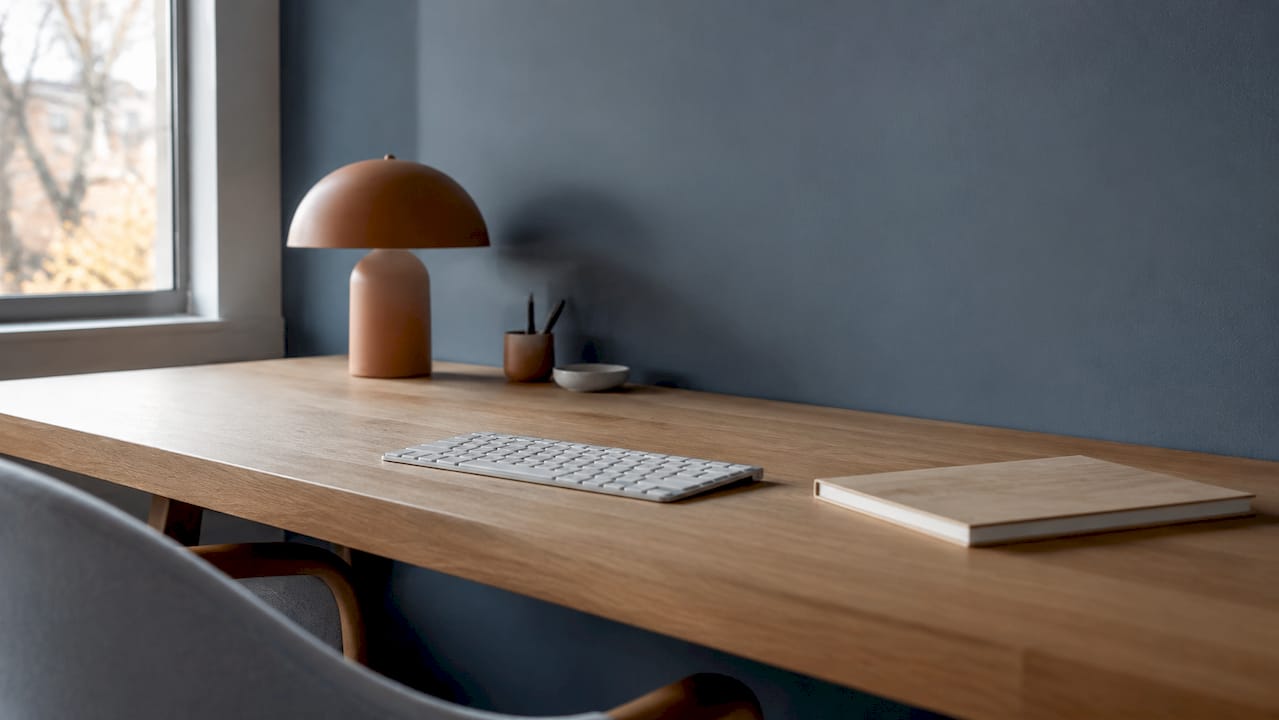 Overhead view of neatly spaced desk objects showing negative space
