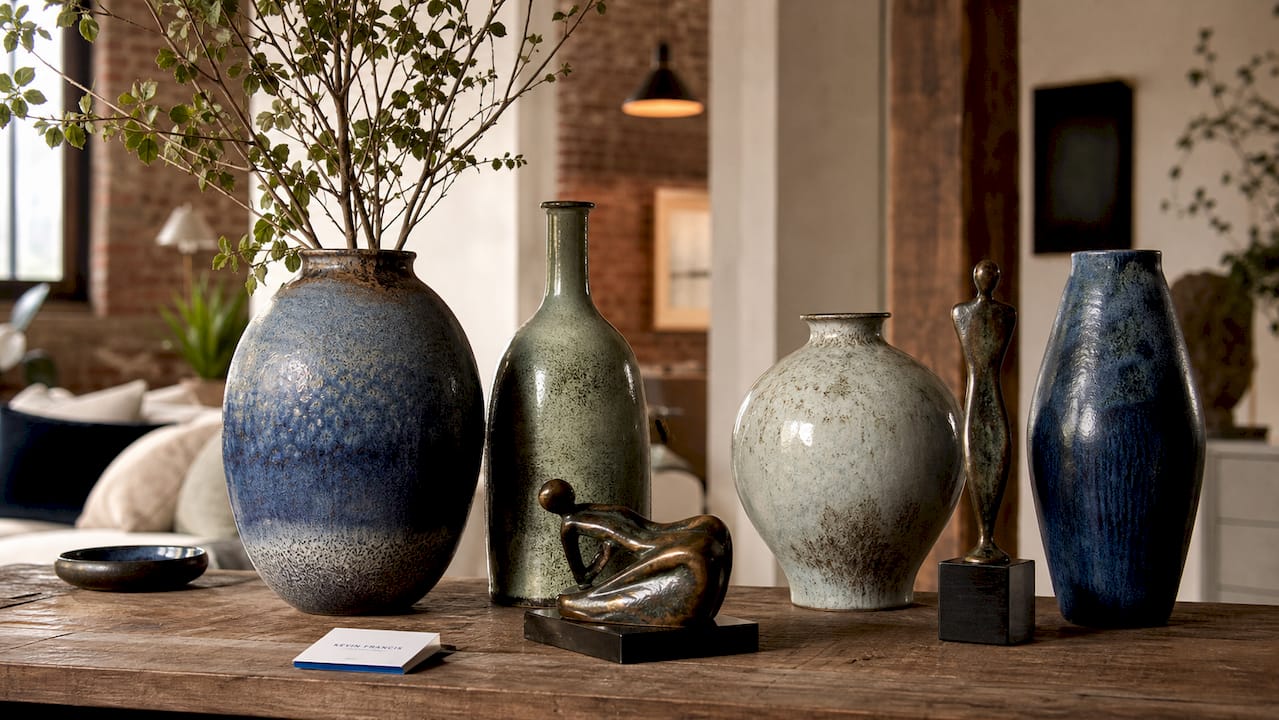 Artisanal ceramic vases and bronze sculptures display